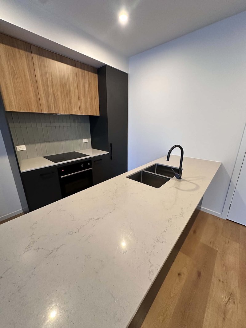 Kitchen benchtop, sink, cabinetry and cooktop following End of Lease Cleaning