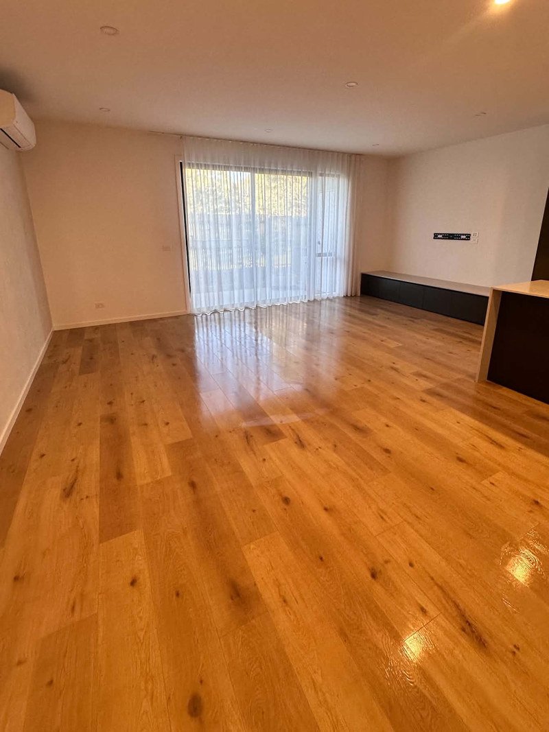 Empty living area and timber floor following End of Lease Cleaning